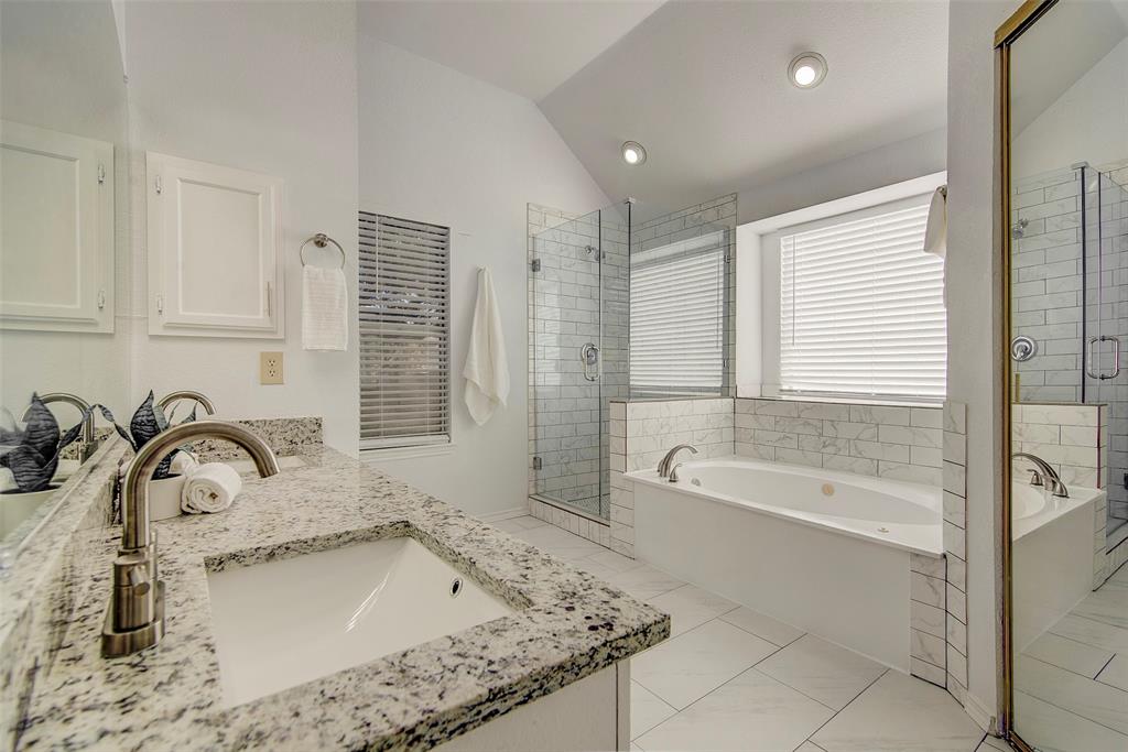 815 Fairlawn Street Allen, TX 75002 - Photo 15 of 22 a bathroom with a granite countertop sink a bathtub and next to a window
