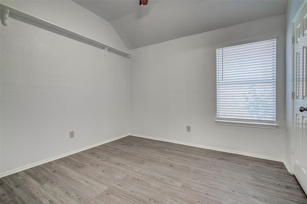 815 Fairlawn Street Allen, TX 75002 - Photo 17 of 22 an empty room with wooden floor and windows