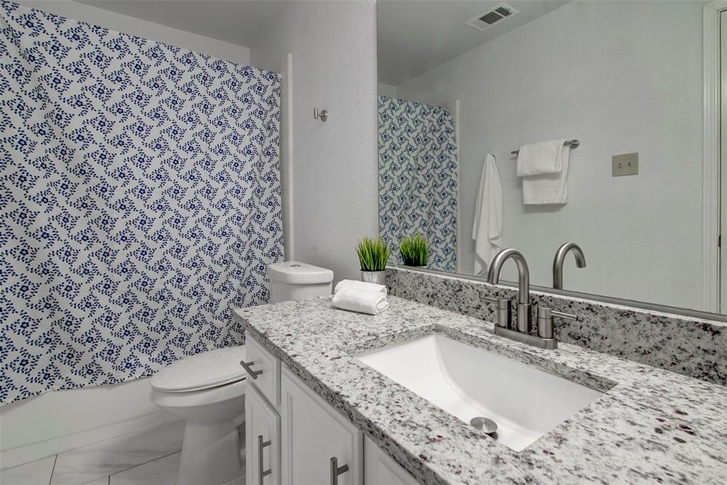 815 Fairlawn Street Allen, TX 75002 - Photo 18 of 22 a bathroom with a granite countertop sink and a toilet