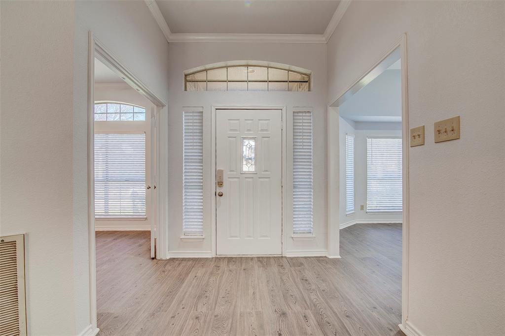 815 Fairlawn Street Allen, TX 75002 - Photo 2 of 22 an empty room with wooden floor and mirror