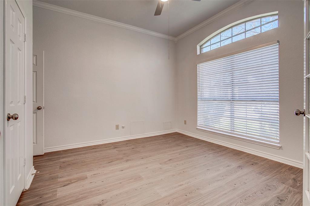 815 Fairlawn Street Allen, TX 75002 - Photo 9 of 22 a view of an empty room with wooden floor and a window