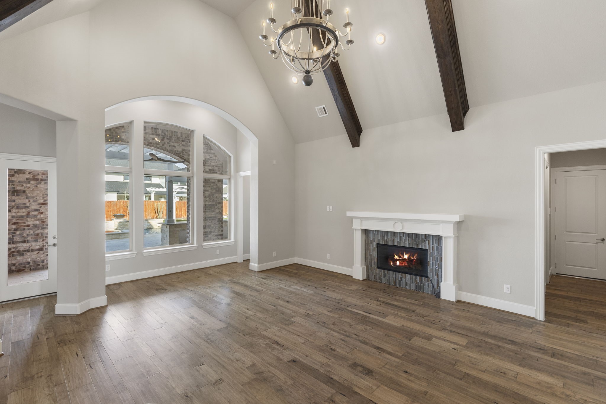 25002 Rosa Aurora Way Spring, TX 77389 - Photo 16 of 38 Large arched windows provide plenty of natural light, and a sweeping staircase adds a touch of luxury.