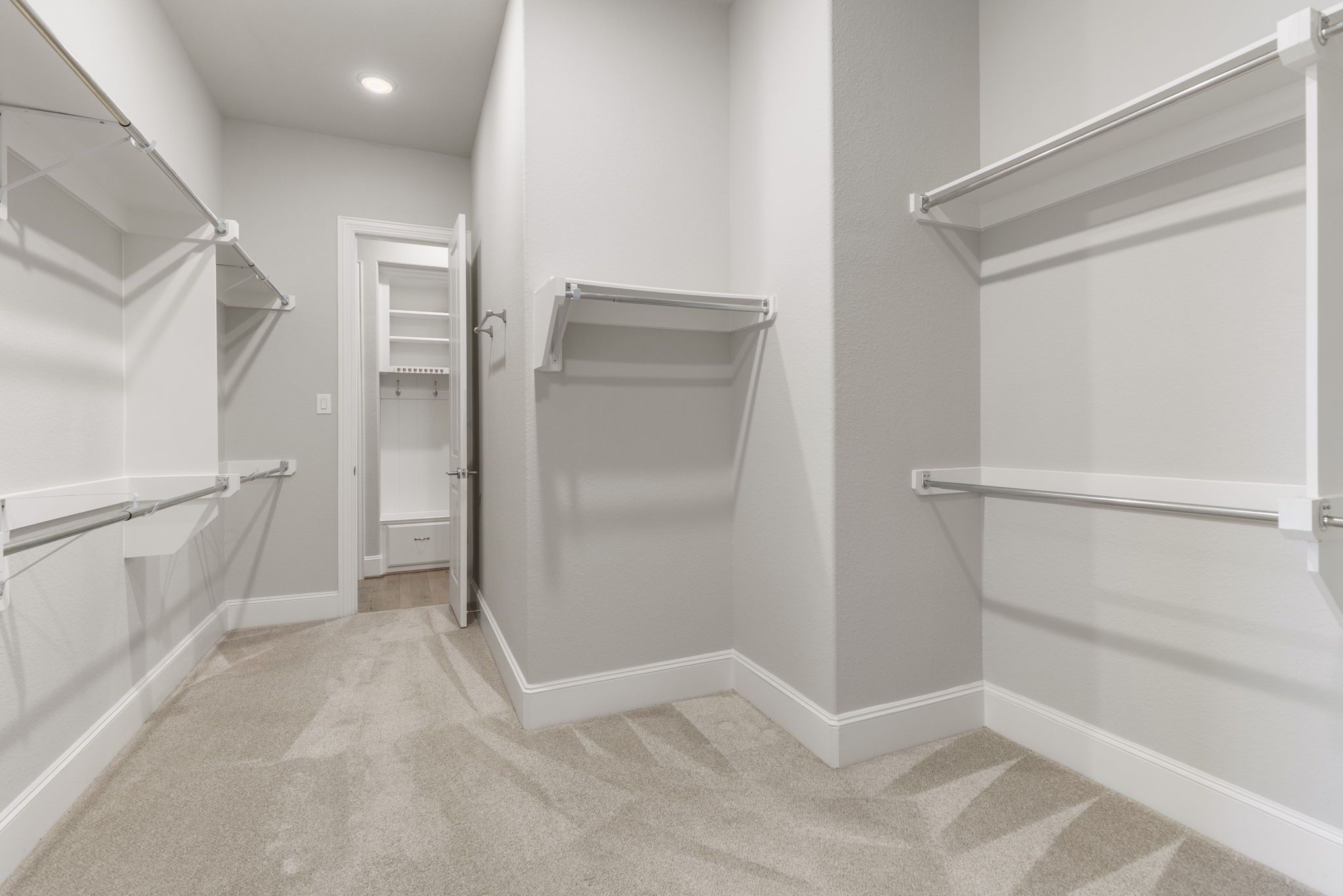 25002 Rosa Aurora Way Spring, TX 77389 - Photo 21 of 38 Spacious walk-in primary closet with multiple shelving units and hanging rods.