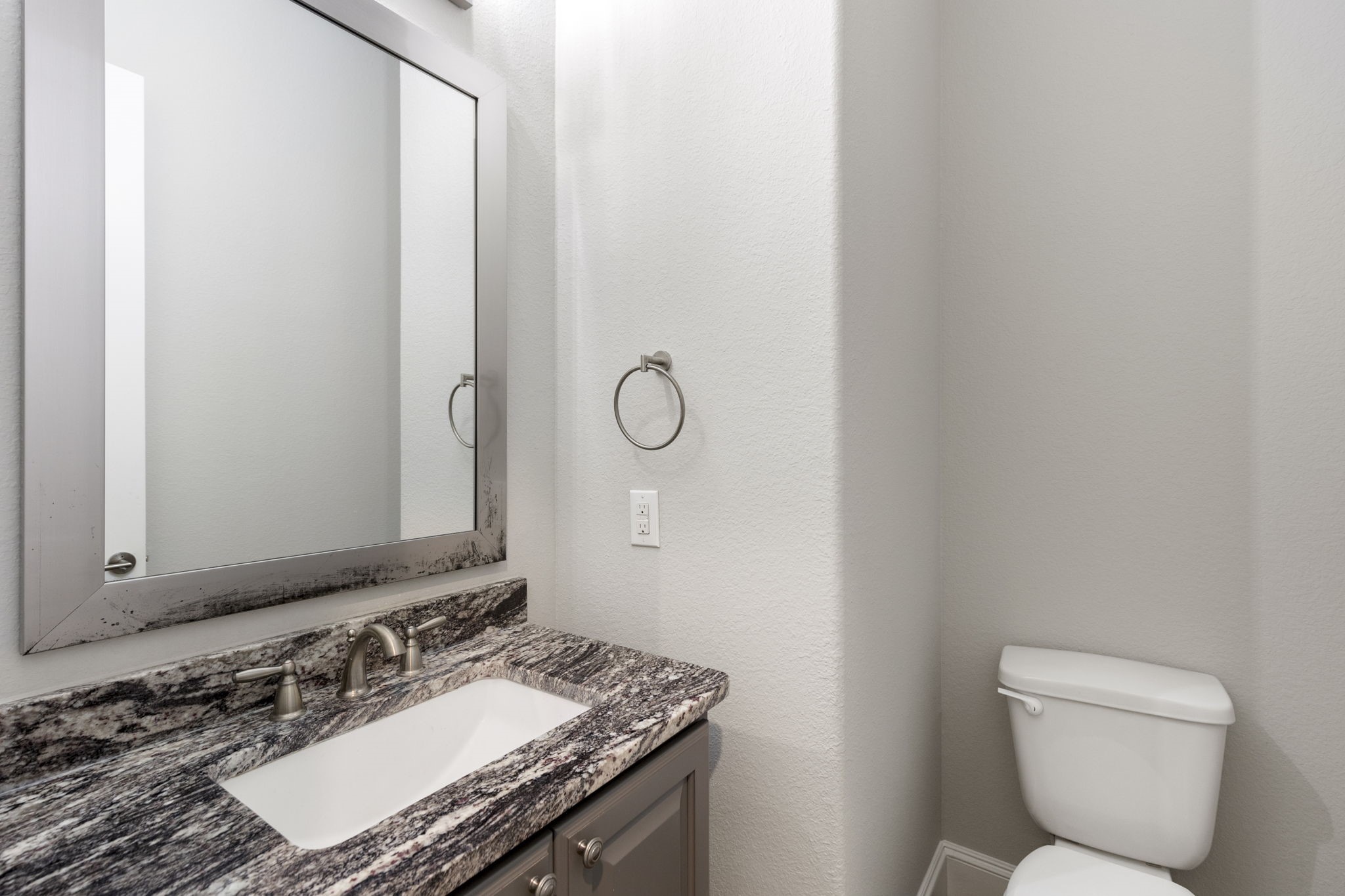 25002 Rosa Aurora Way Spring, TX 77389 - Photo 24 of 38 Half bathroom featuring a modern design with a granite countertop, undermount sink, and sleek fixtures.