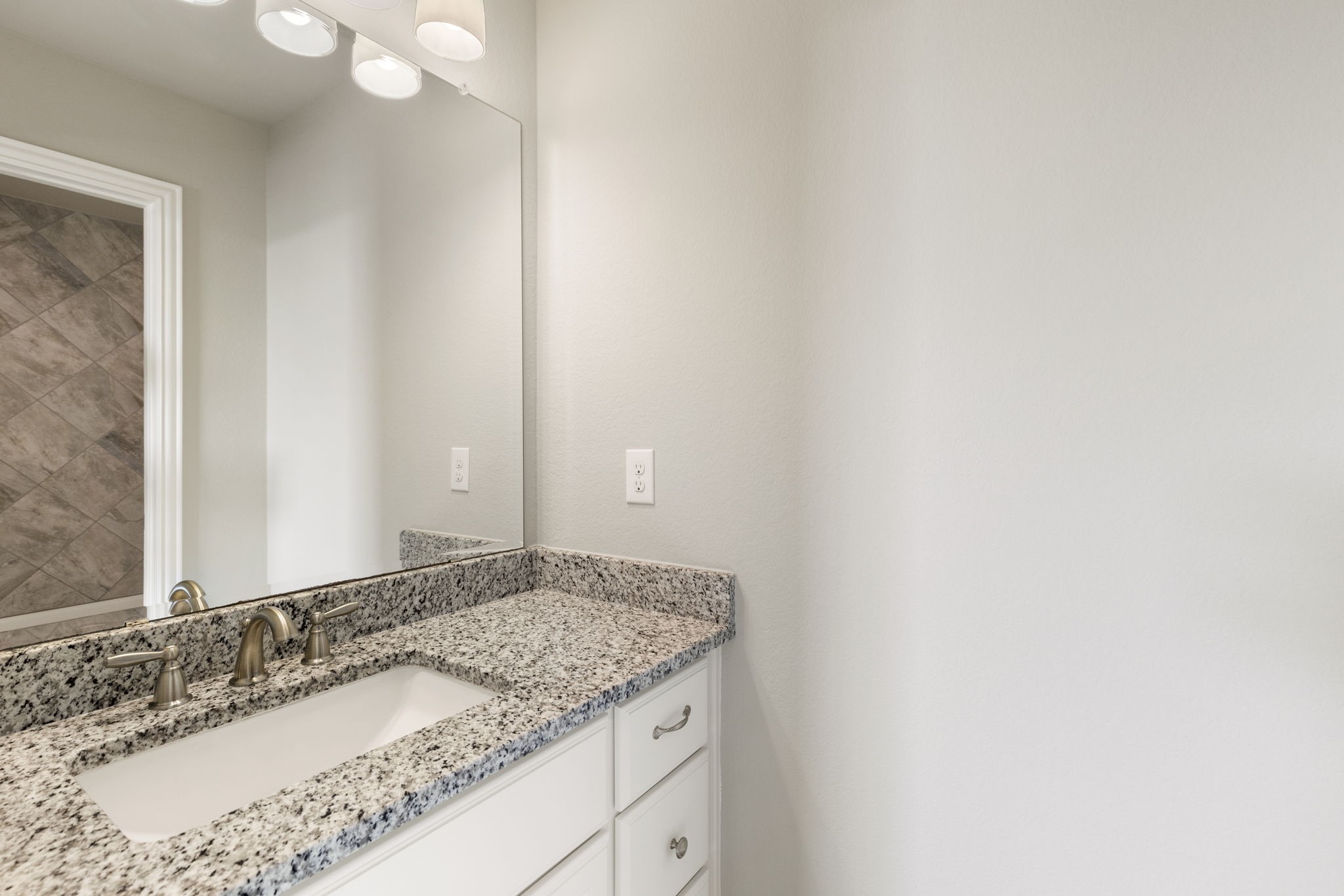 25002 Rosa Aurora Way Spring, TX 77389 - Photo 30 of 38 This photo features jack and jill bathroom with a granite countertop and an under-mount sink.