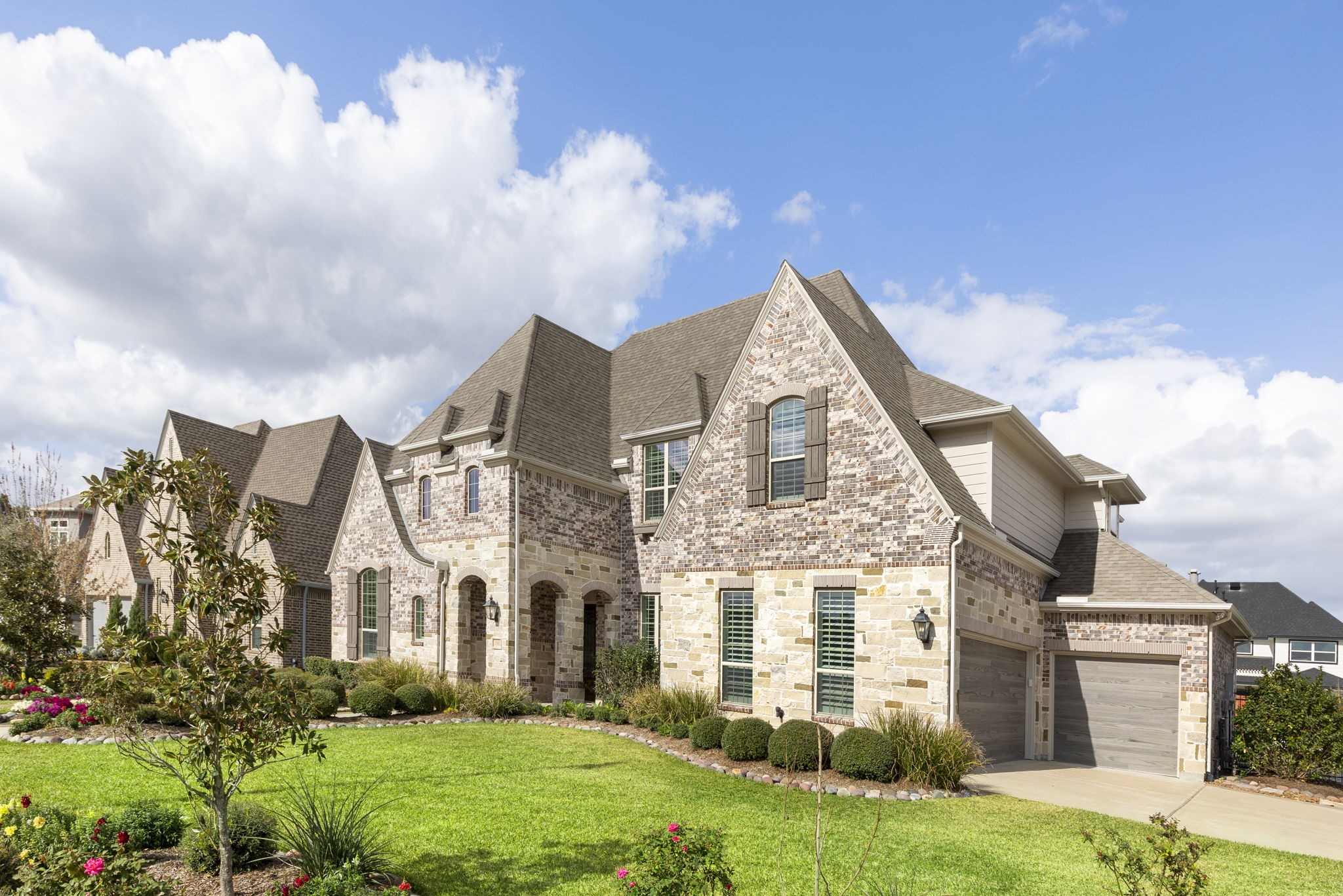 25002 Rosa Aurora Way Spring, TX 77389 - Photo 3 of 38 The well-manicured lawn and landscaping add to its curb appeal, and the dual garages provide ample parking space.