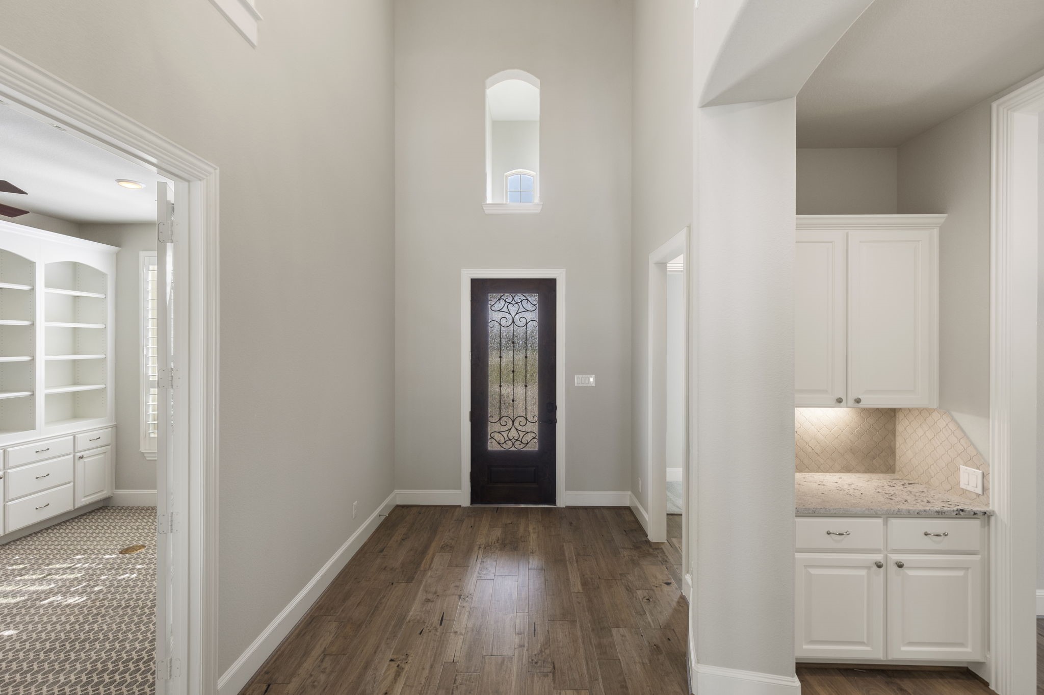 25002 Rosa Aurora Way Spring, TX 77389 - Photo 5 of 38 This photo showcases a bright, open entryway with high ceilings, featuring a decorative glass front door.