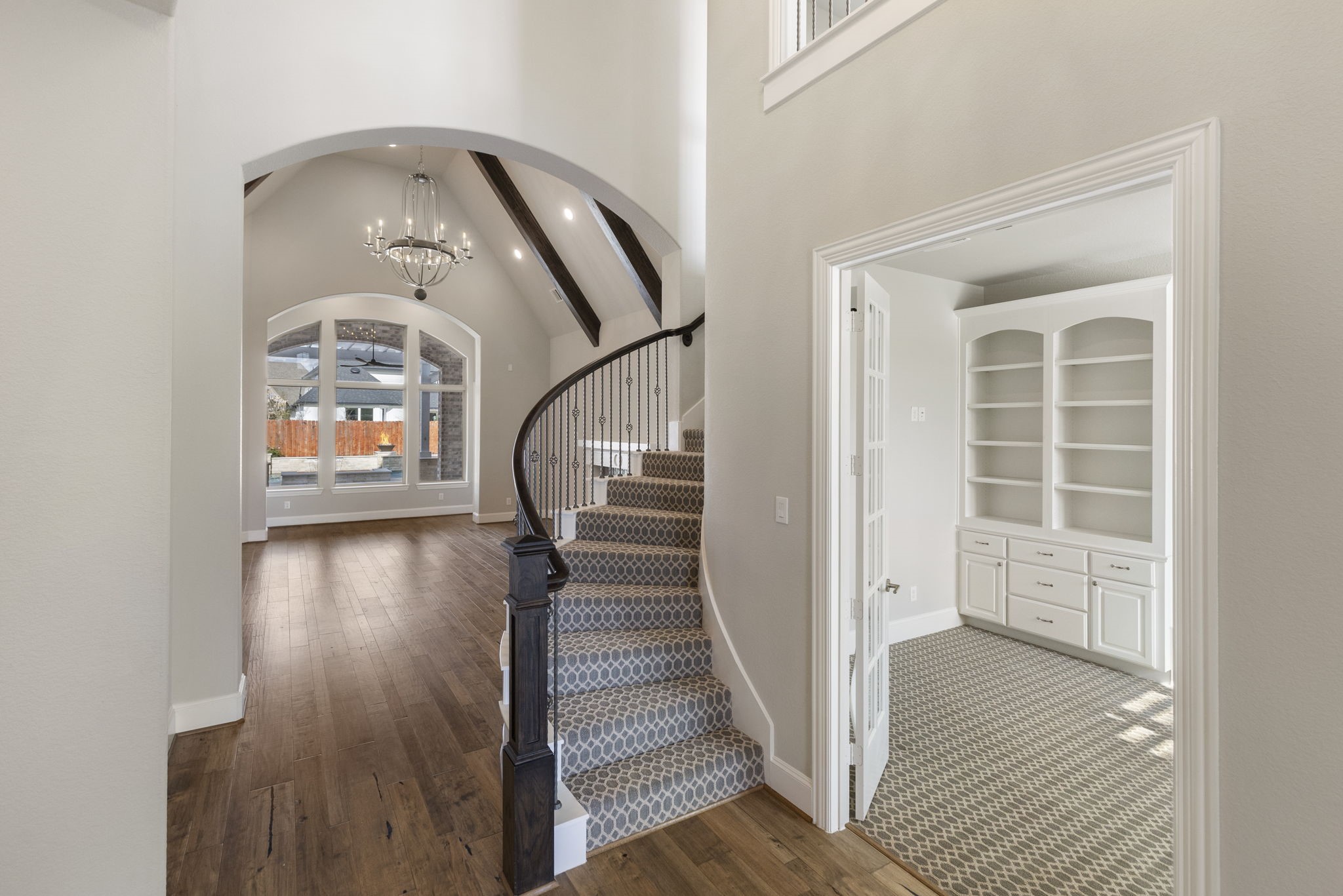 25002 Rosa Aurora Way Spring, TX 77389 - Photo 6 of 38 This elegant home features a spacious entryway with a curved staircase, high ceilings, and a chandelier.