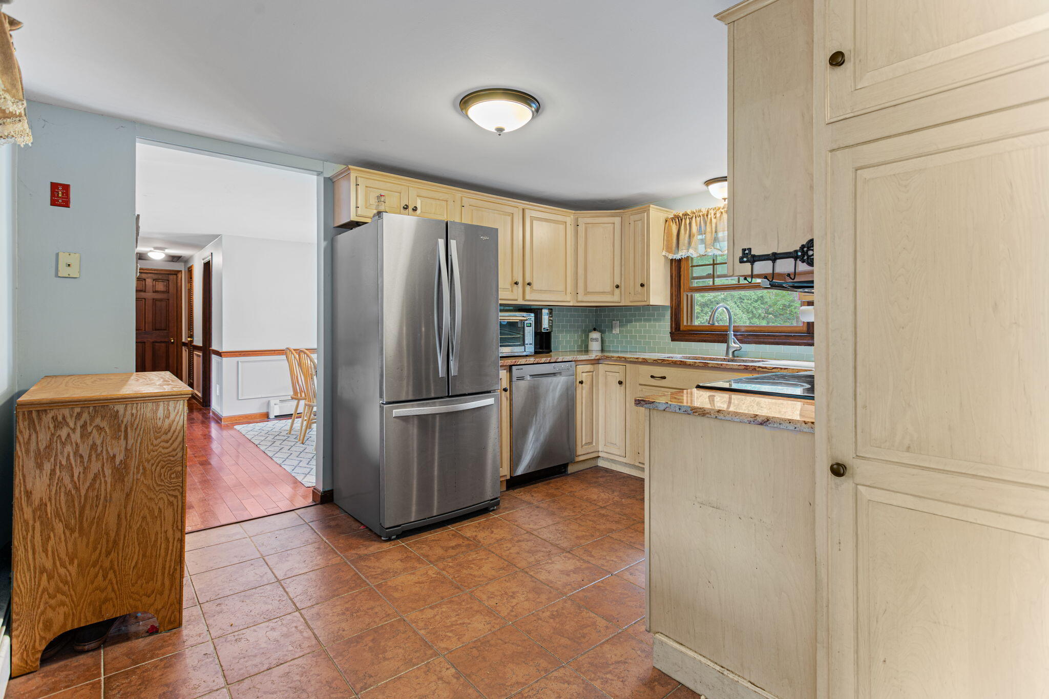 23 Meredith Road Forestdale, MA 02644 - Photo 5 of 22 a kitchen with a refrigerator a stove top oven and cabinets