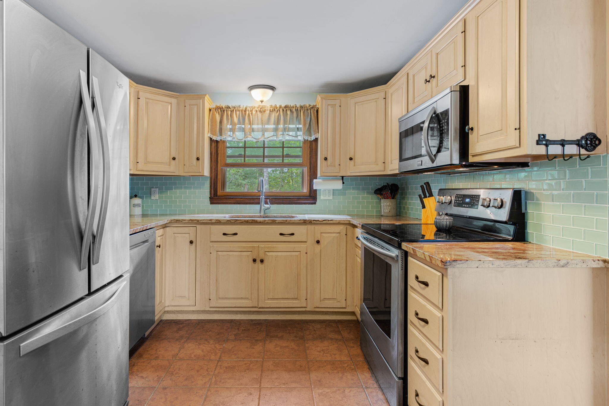 23 Meredith Road Forestdale, MA 02644 - Photo 6 of 22 a kitchen with stainless steel appliances granite countertop a refrigerator sink and stove