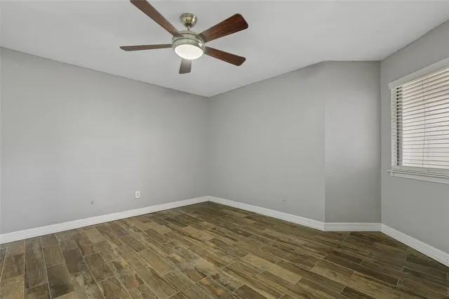 wooden floor in an empty room with a window