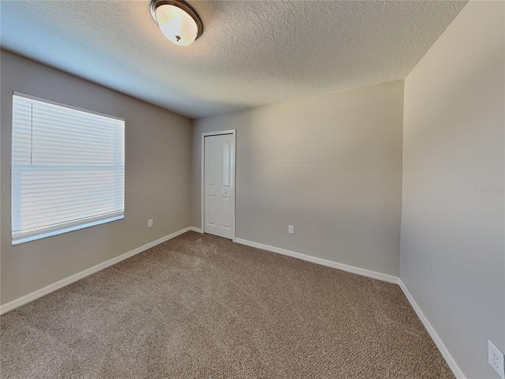 Undisclosed Address Spring Hill, FL 34609 - Photo 11 of 15 an empty room with windows