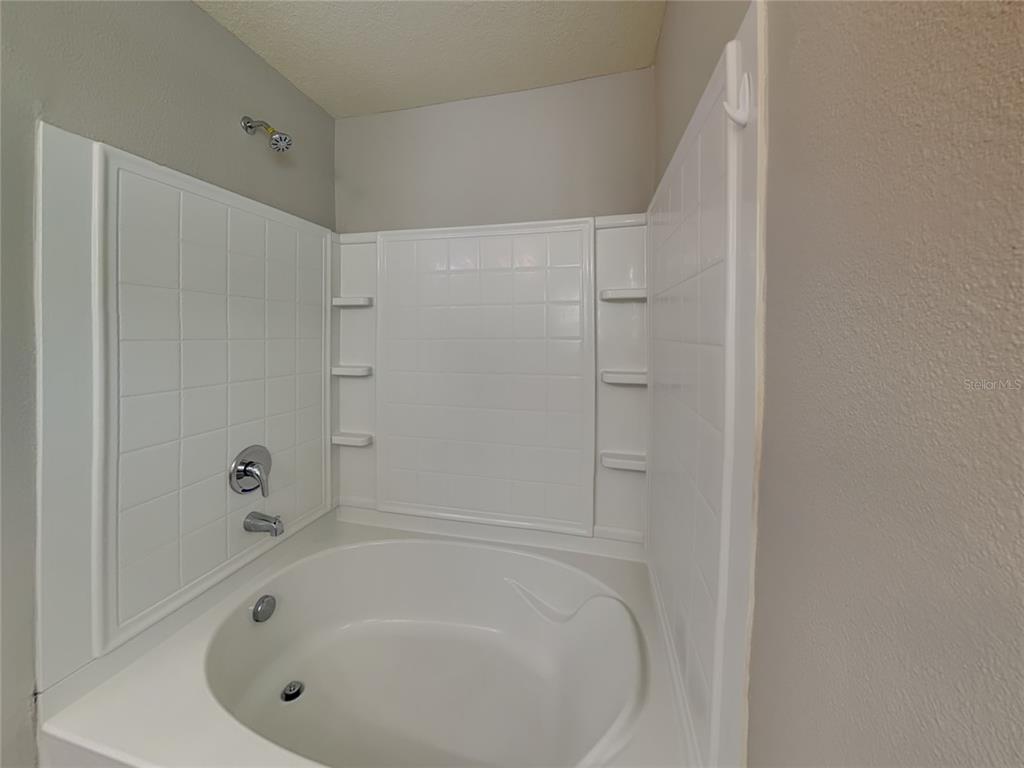 Undisclosed Address Spring Hill, FL 34609 - Photo 8 of 15 a bathroom with a tub