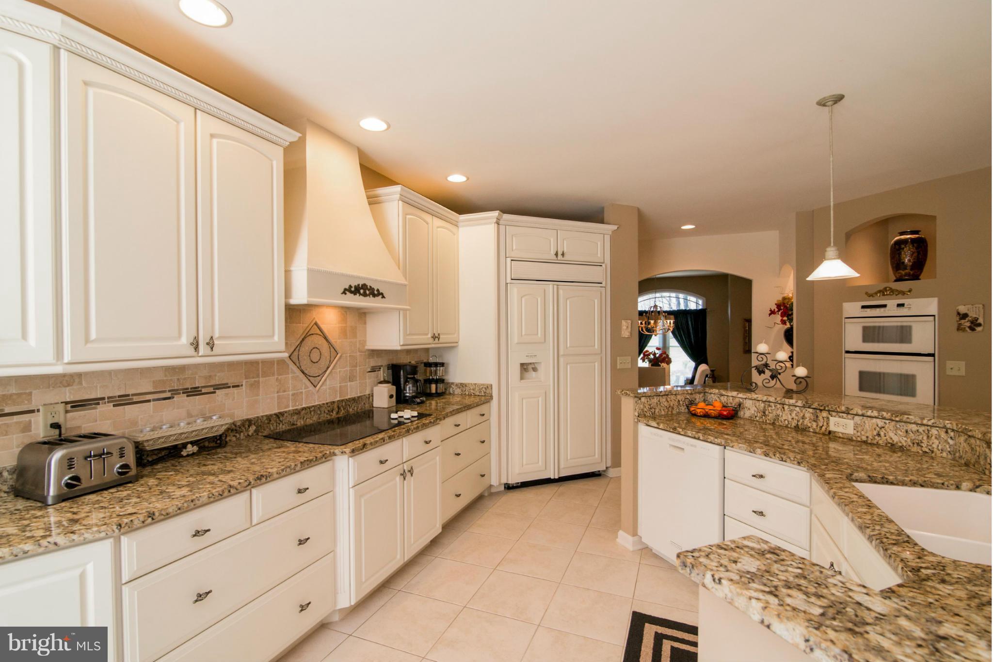 16511 York Road Monkton, MD 21111 - Photo 16 of 30 a large kitchen with kitchen island granite countertop a sink and white cabinets