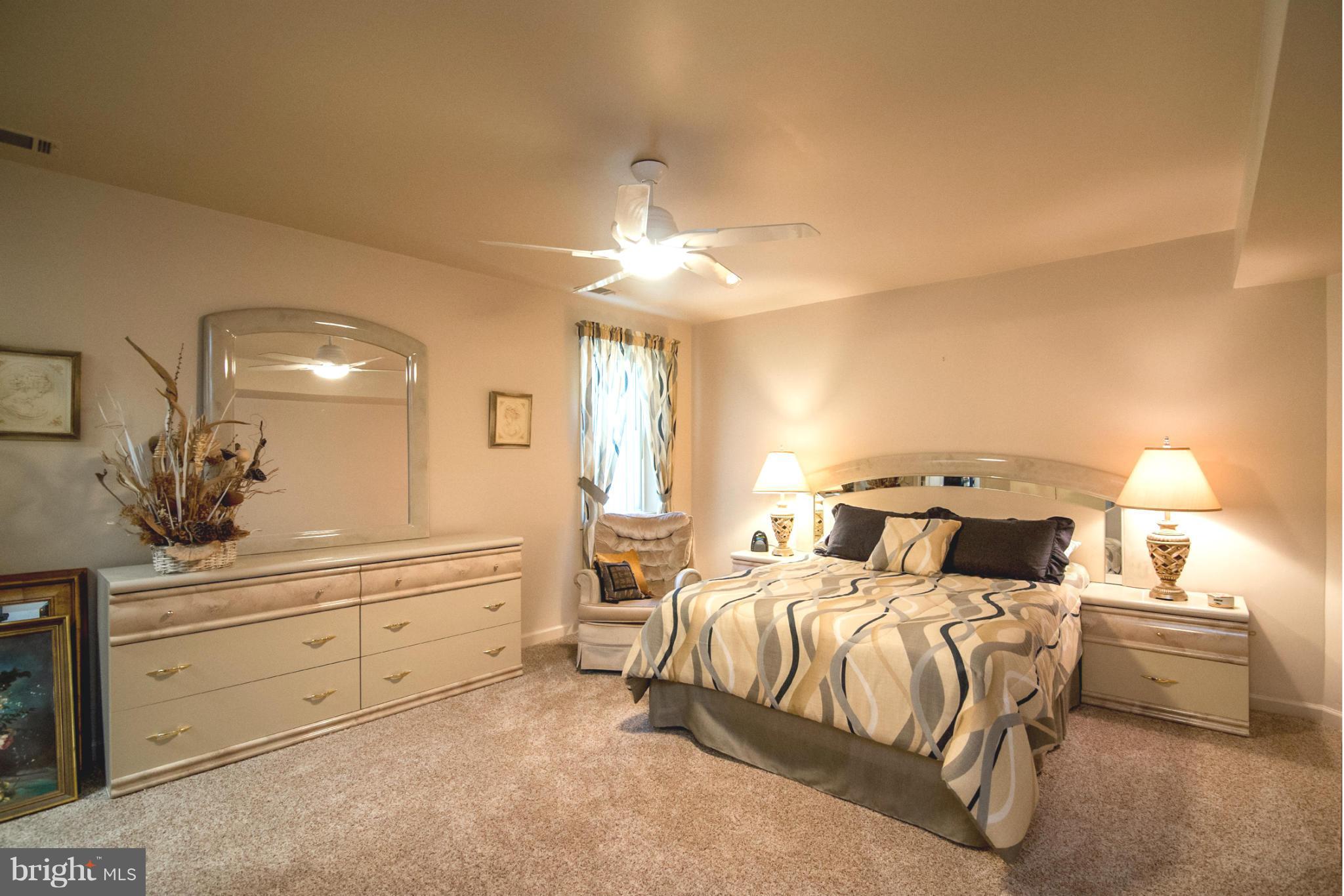 16511 York Road Monkton, MD 21111 - Photo 28 of 30 a bedroom with a bed and a chandelier