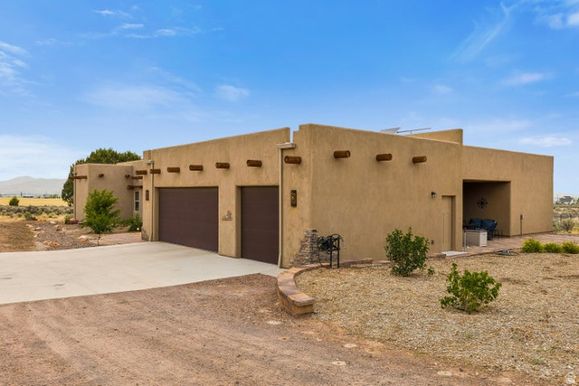 2925 Juniper Road Enterprise, UT 84725 - Photo 35 of 56 View of front of property featuring concrete driveway, stucco siding, and an attached garage