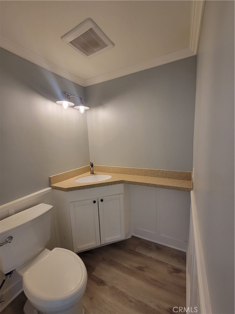 14325 Blackpool Road Westminster, CA 92683 - Photo 13 of 28 a bathroom with a toilet a sink and mirror
