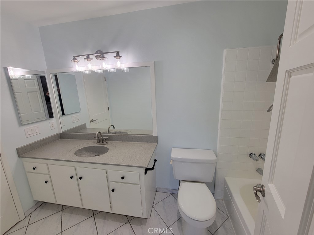 14325 Blackpool Road Westminster, CA 92683 - Photo 19 of 28 a bathroom with a toilet sink and mirror