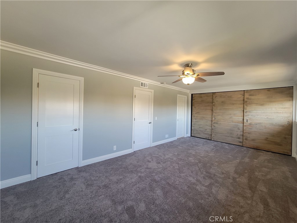 14325 Blackpool Road Westminster, CA 92683 - Photo 21 of 28 an empty room with a fan and a chandelier fan