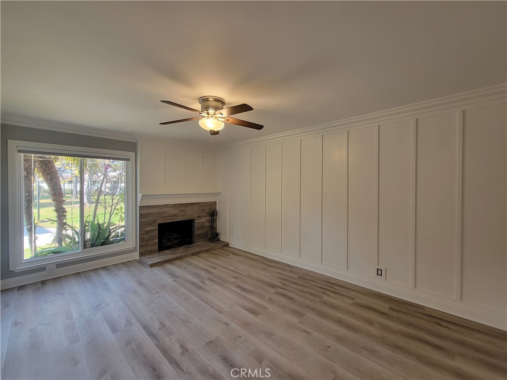 14325 Blackpool Road Westminster, CA 92683 - Photo 5 of 28 wooden floor fireplace and windows in an empty room