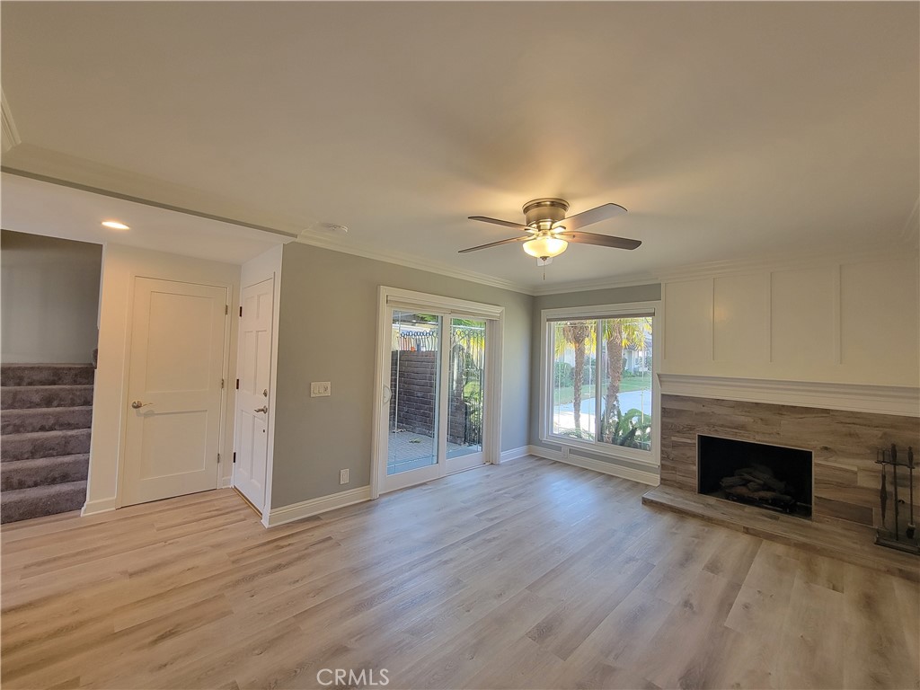 14325 Blackpool Road Westminster, CA 92683 - Photo 7 of 28 an empty room with wooden floor fireplace and windows