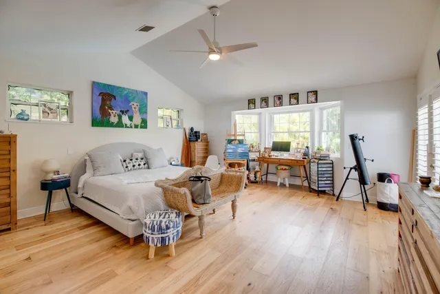 a spacious bedroom with a bed and a large window