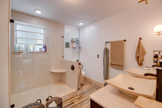 a bathroom with a sink toilet and shower