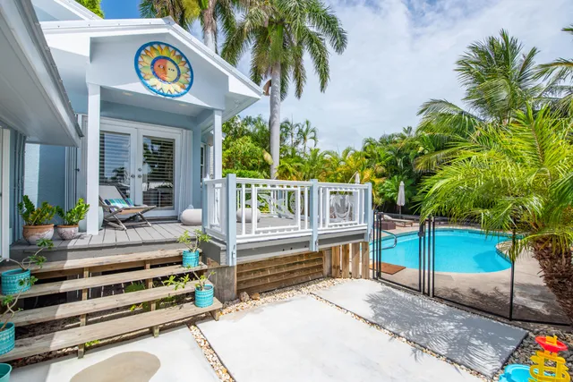 a view of a patio with chairs and potted plants