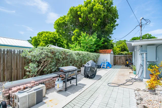 a front view of a house with patio and garden