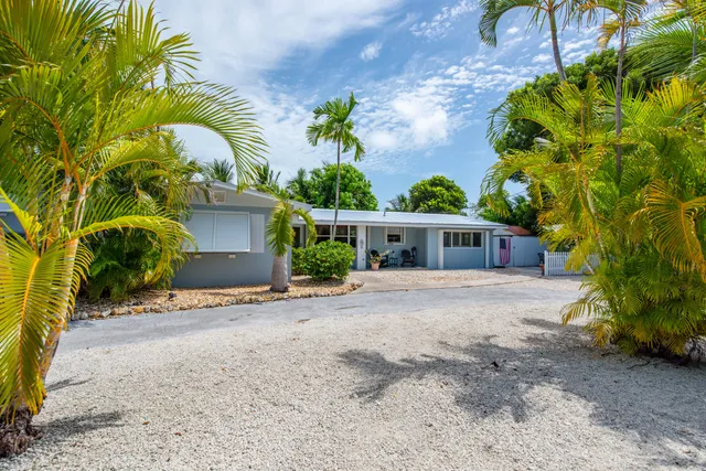 a front view of a house with a yard and a garage