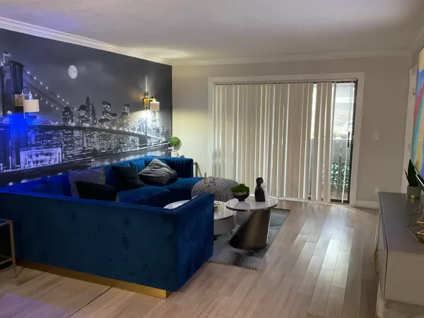 a living room with furniture and wooden floor