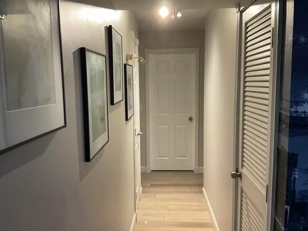 a bathroom with a glass shower door and a mirror