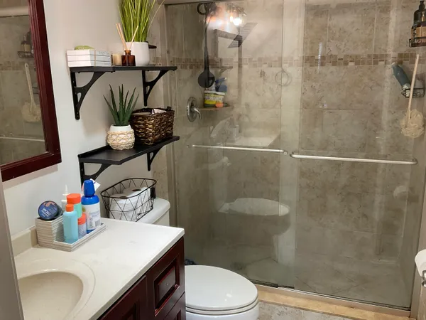 a bathroom with a sink toilet and shower