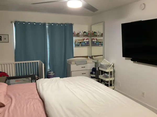 a bedroom with a bed and flat screen tv