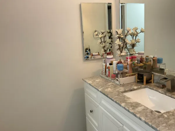 a bathroom with mirror sink and vanity
