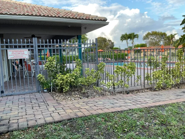 a view of a house with a small yard and plants