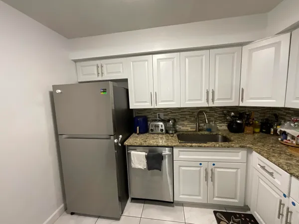 a white refrigerator freezer sitting in a kitchen