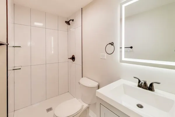 a bathroom with a sink toilet and shower
