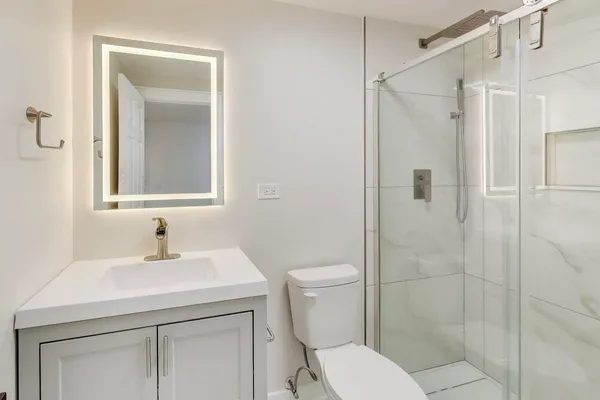 a bathroom with a sink toilet and shower