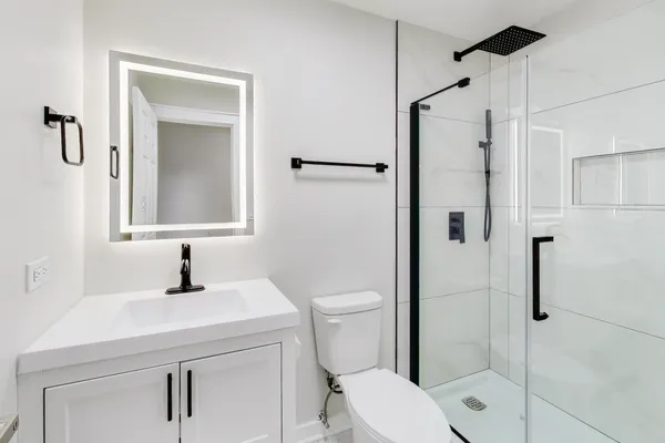 a bathroom with a sink toilet and shower