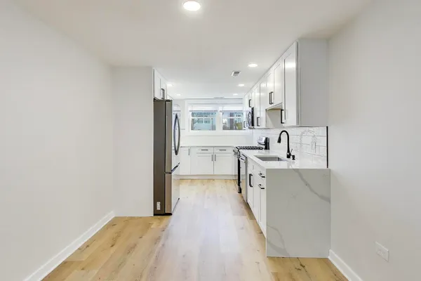 a view of a kitchen with electric appliances