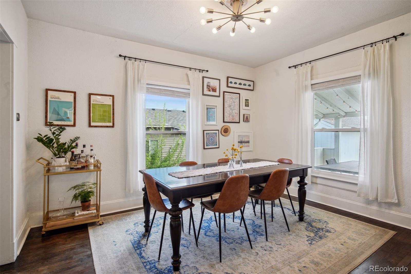 60 Perry Street Denver, CO 80219 - Photo 12 of 43 a view of a dining room with furniture window and wooden floor