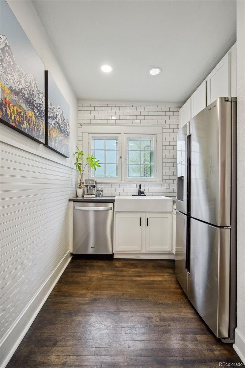 60 Perry Street Denver, CO 80219 - Photo 19 of 43 a kitchen with stainless steel appliances a refrigerator sink and white cabinets