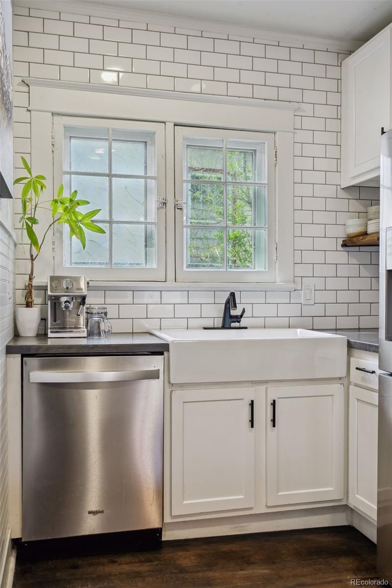 60 Perry Street Denver, CO 80219 - Photo 20 of 43 a sink with white cabinets and a wooden floor