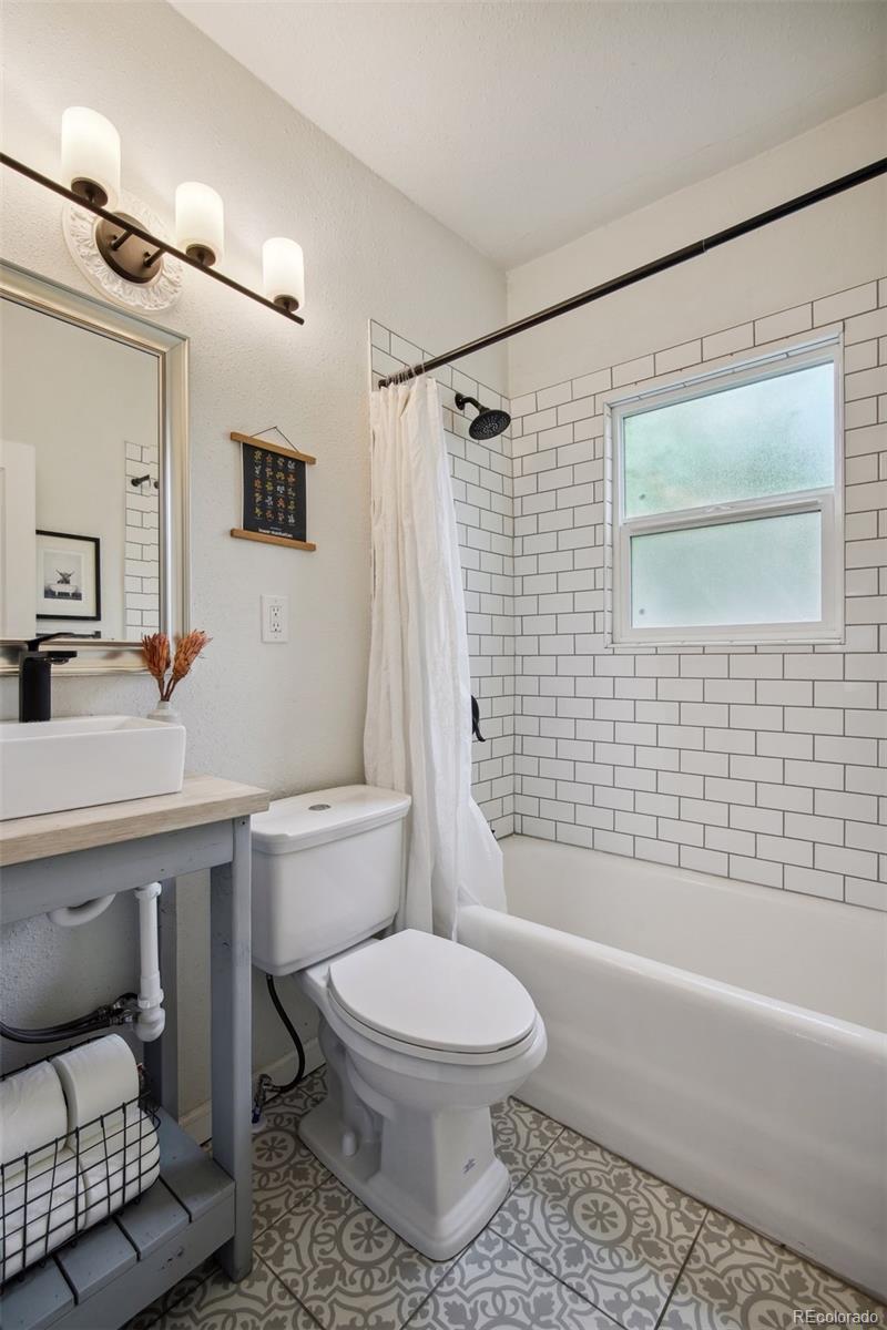 60 Perry Street Denver, CO 80219 - Photo 21 of 43 a bathroom with a toilet a sink and bathtub