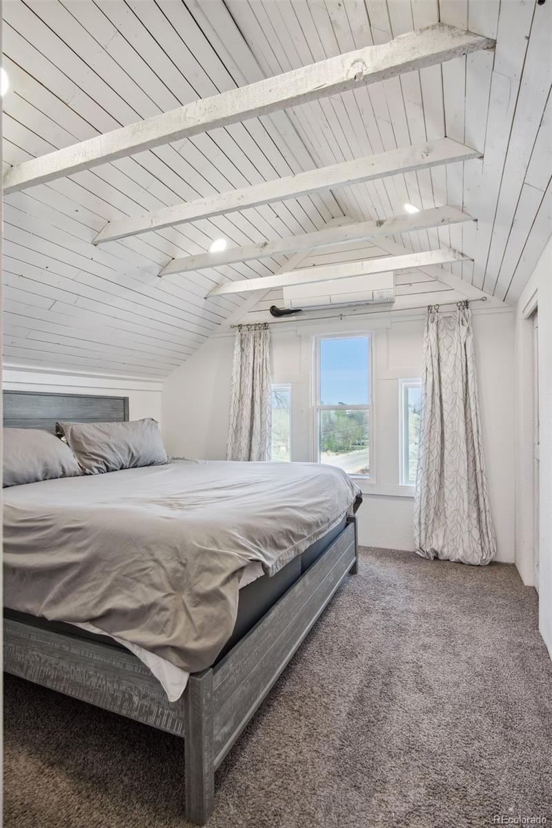 60 Perry Street Denver, CO 80219 - Photo 24 of 43 a spacious bedroom with a bed and a window