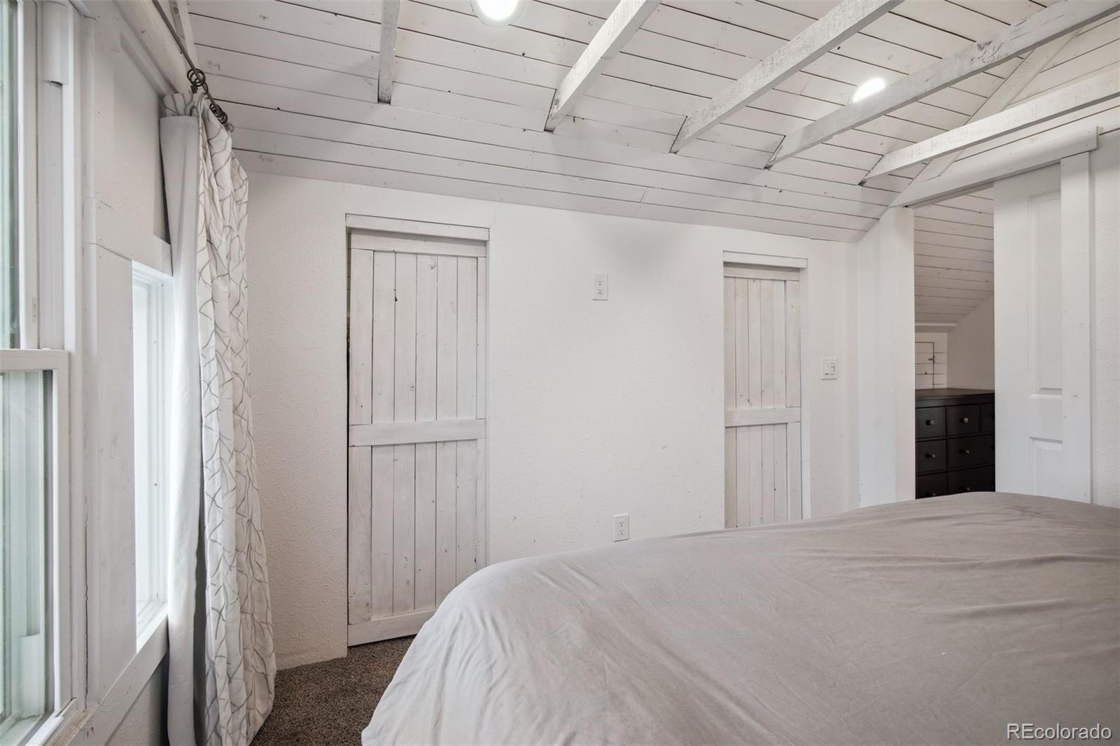 60 Perry Street Denver, CO 80219 - Photo 25 of 43 a bedroom with a bed and a window