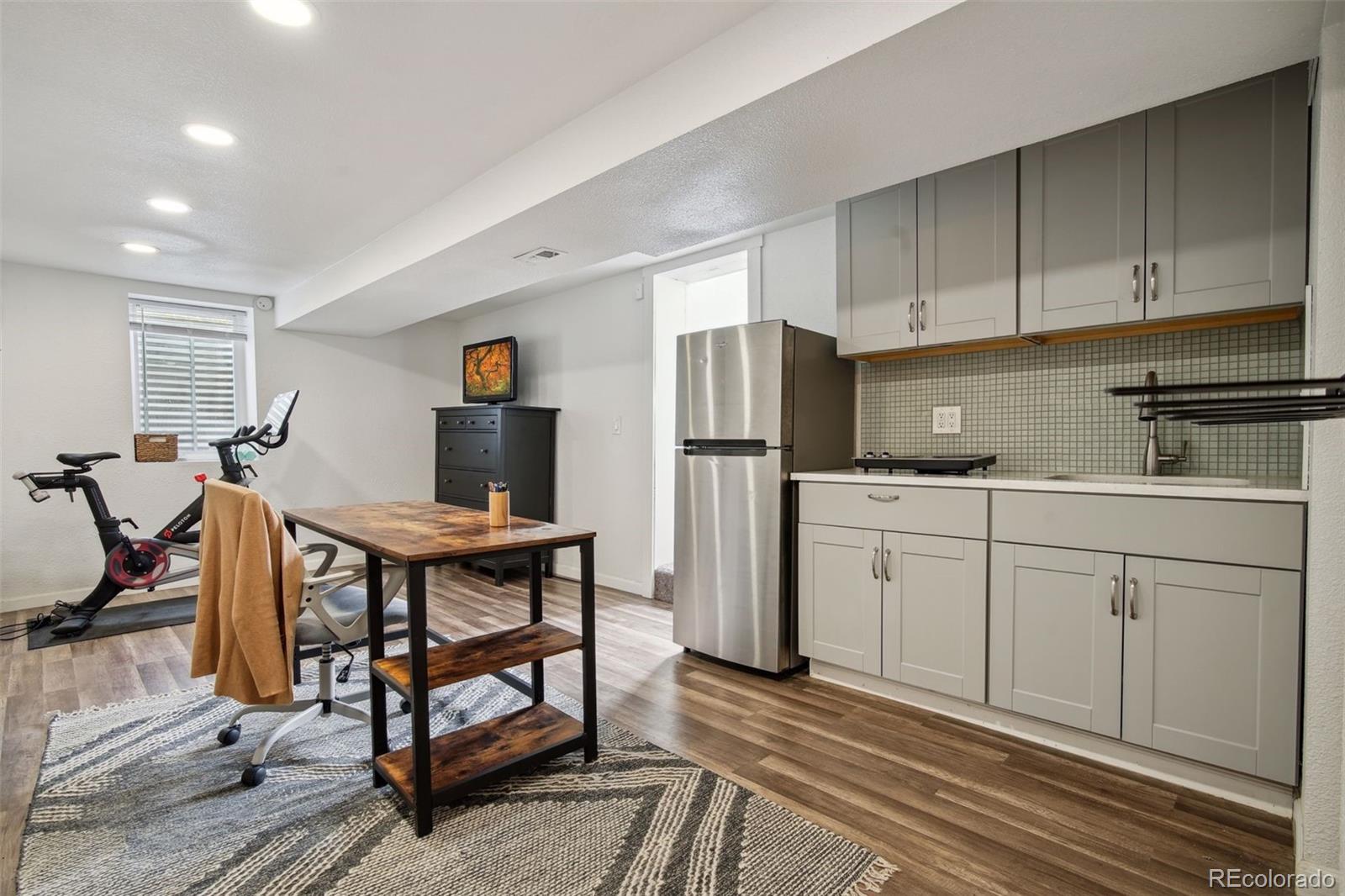 60 Perry Street Denver, CO 80219 - Photo 30 of 43 a kitchen that has a refrigerator a table and chairs in it