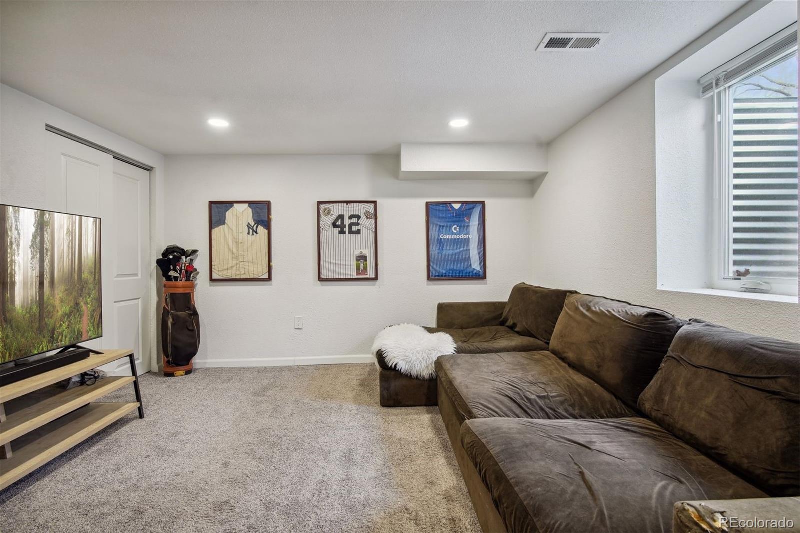 60 Perry Street Denver, CO 80219 - Photo 33 of 43 a living room with furniture and a flat screen tv