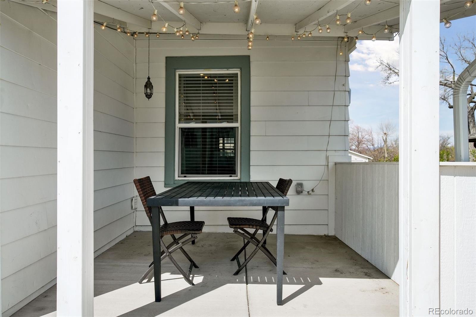 60 Perry Street Denver, CO 80219 - Photo 37 of 43 a patio with table and chairs and potted plants